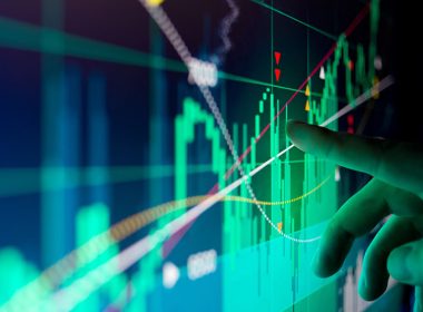 A close-up of a worker inspecting data on a screen.