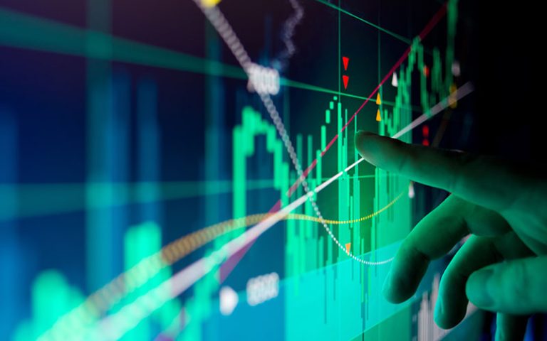 A close-up of a worker inspecting data on a screen.